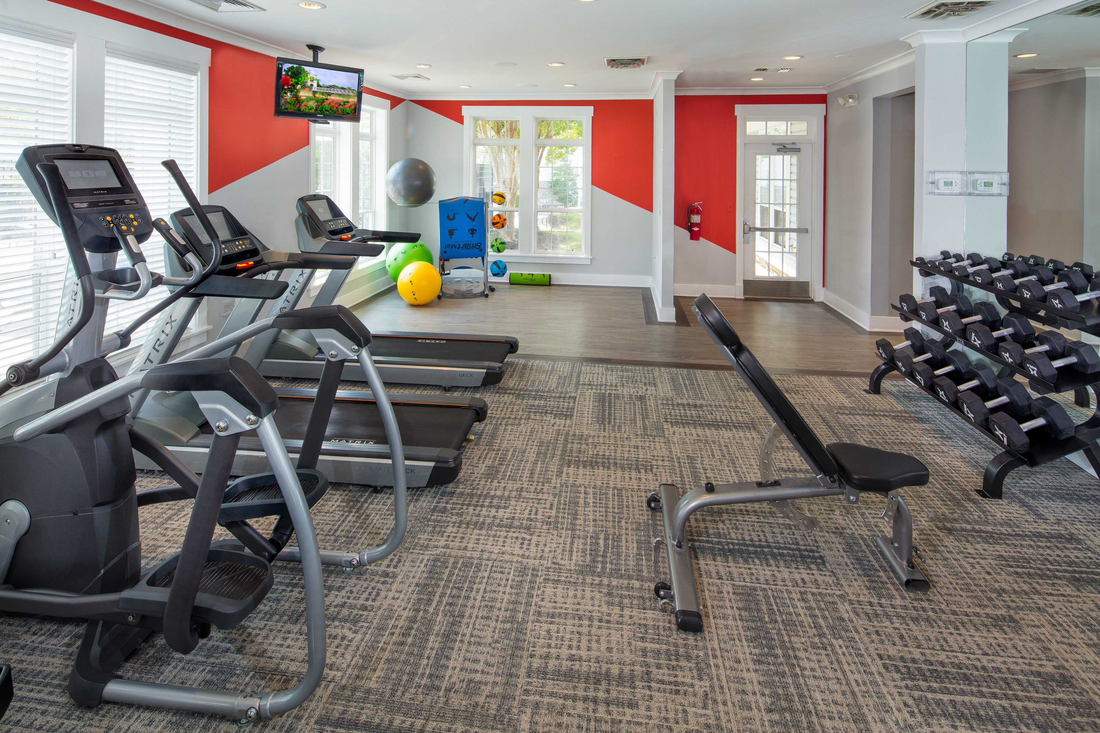 fitness center with various exercise equipment, cardio machines and free weights - ashburn va luxury apartments