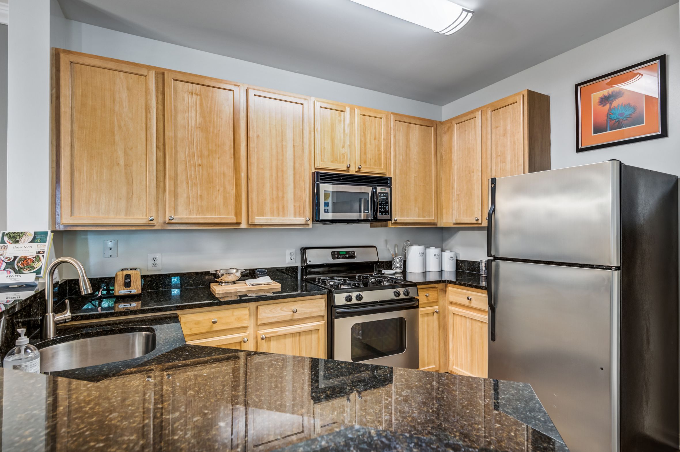 kitchen with bar area, granite counters and stainless steel appliances - ashburn va apartments